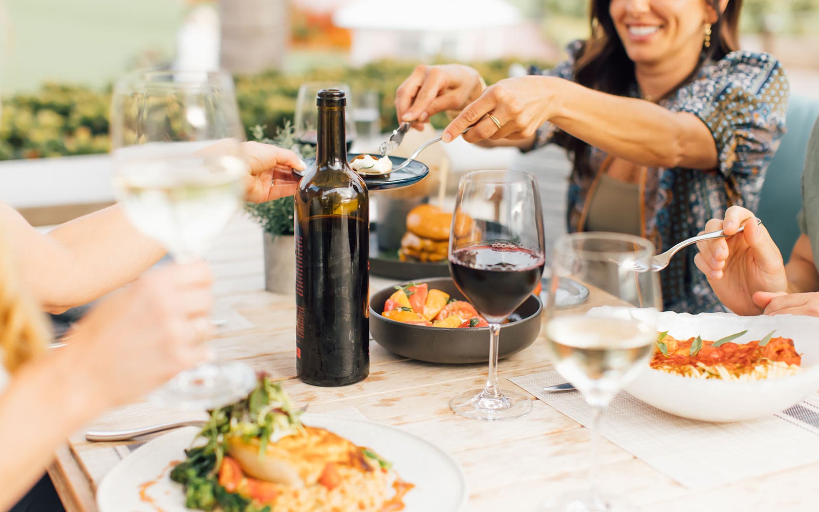 Closeup image of friends having dinner with wine